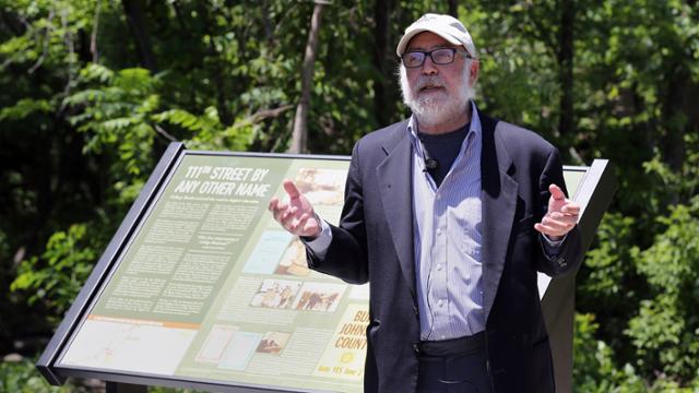 Henry Fortunato giving a talk in front of a historical marker on the Indian Creek Bike and Hike Trail.