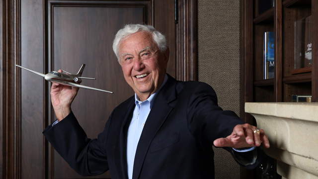 Hugh Libby holding a model airplane as if to toss it.
