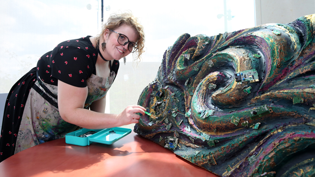 Graphic Design student Roxanne Wright works on her artwork for the TSC.