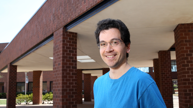 Jason Soltys standing near the courtyard by the OCB building