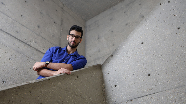 Jarar Bangash posing on the concrete circular stairs in the GEB building