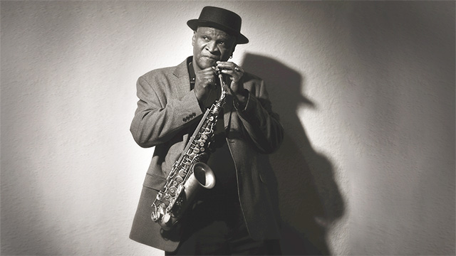 Bobby Watson holding a saxophone.