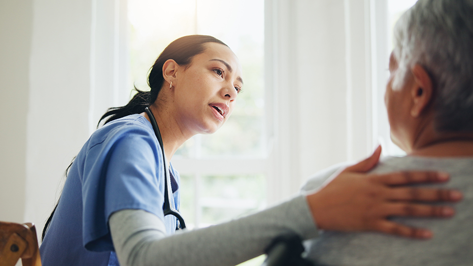A nurse consults with a patient in a medical setting.