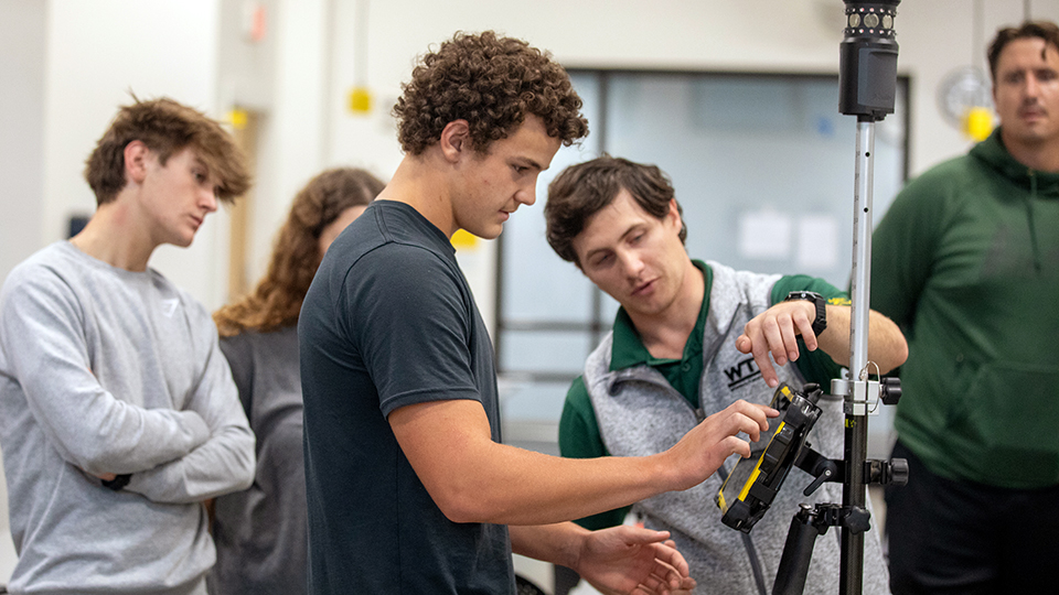 A group of students working with construction equipment