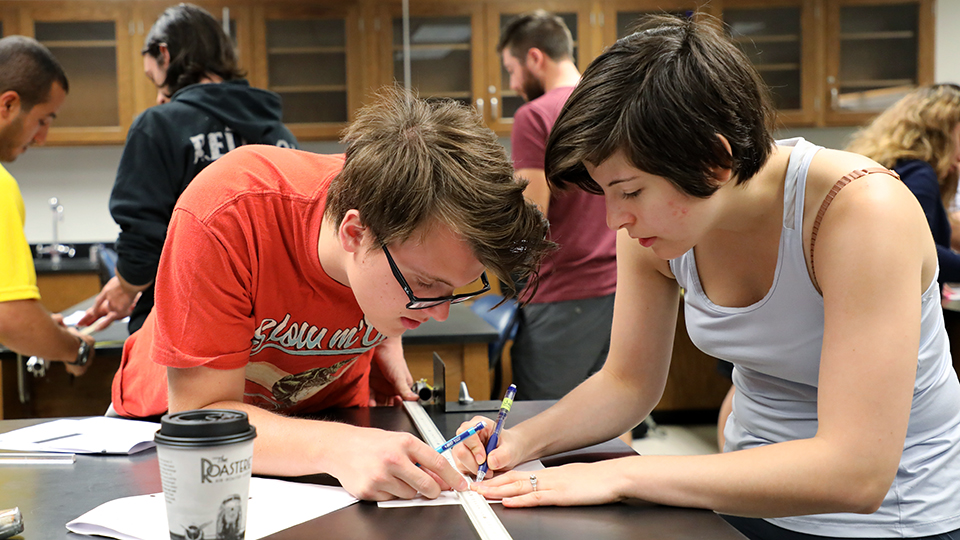 Two students working on an engineering project