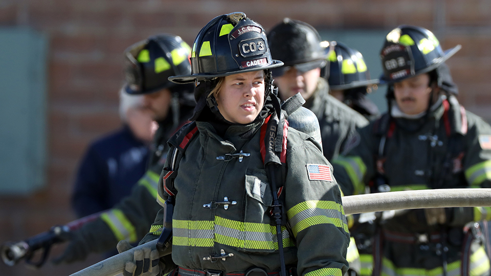A firefighter holding a hose.