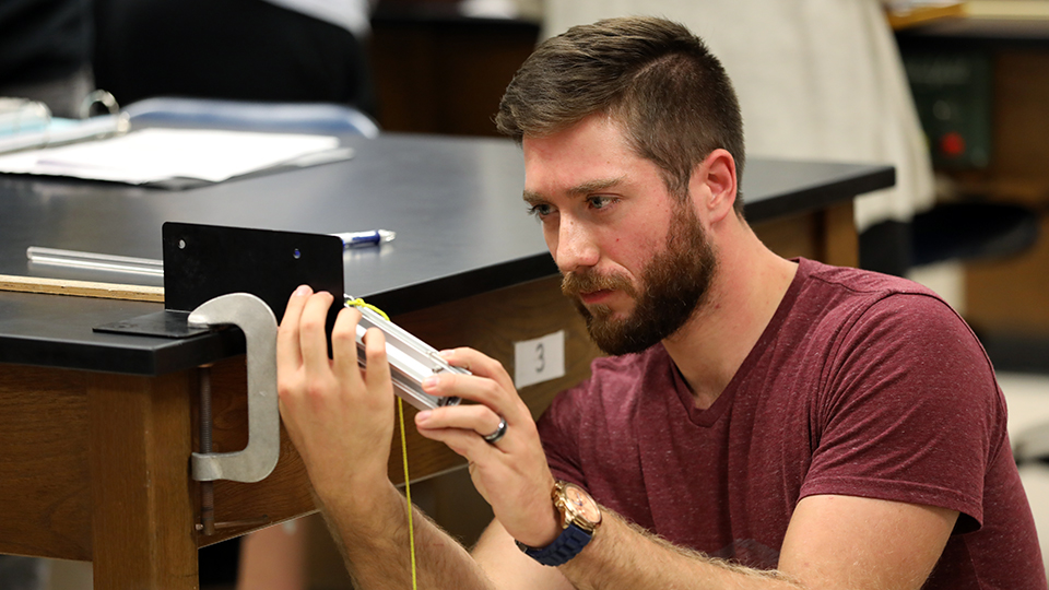 Student completing a physics experiment