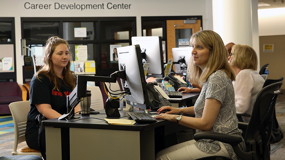 Two people sit at work stations in the Career Development Center, which is in the Student Success Center