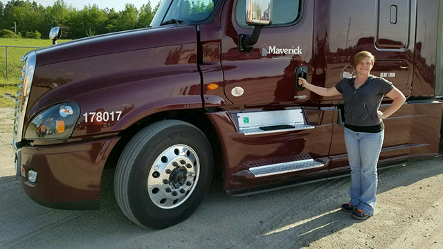 Amanda Lord standing by a semi cab