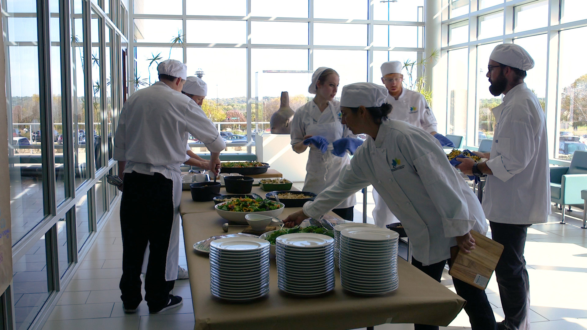 Culinary students setting tables