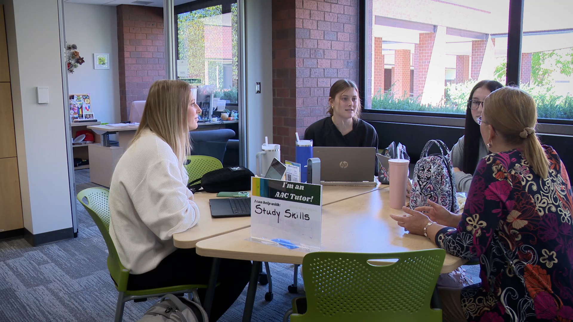Tutor working with students in the Academic Achievement Center