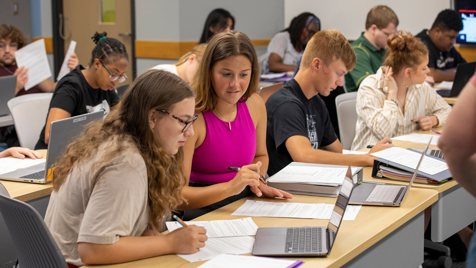 jccc classroom full of students working on papers and laptops