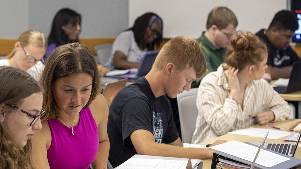 A class of students working at their desks.