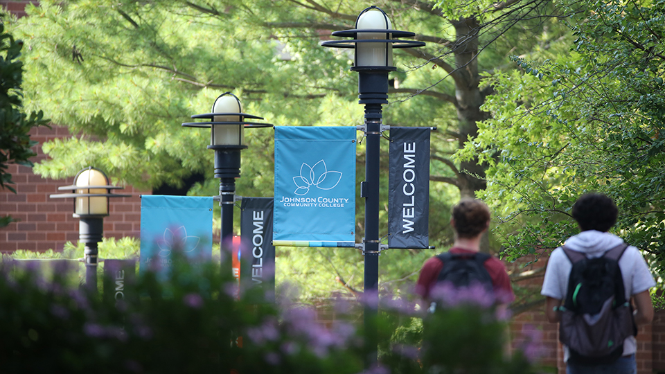 students walking under welcome banners