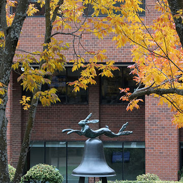 Hare and Bell sculpture in Fountain Square, surround by trees with fall leaf colors