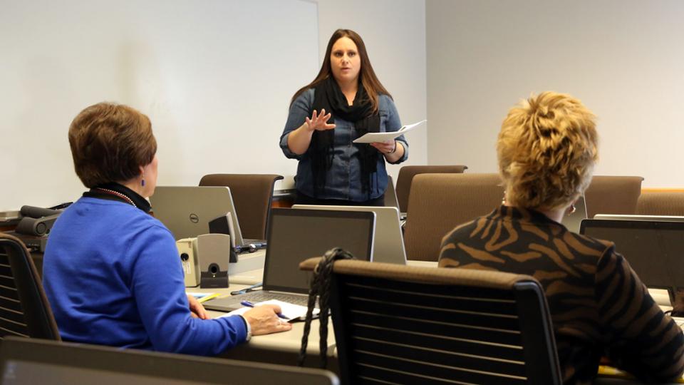 A member of the HR team talks to two adult women