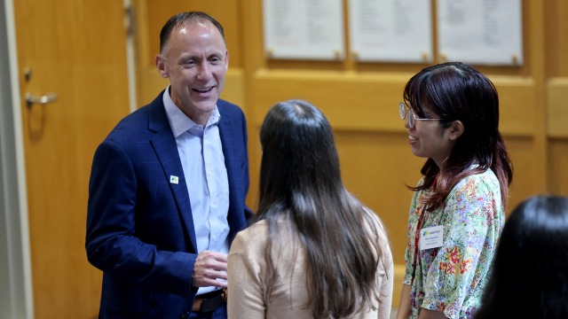 Dr. Tony Miksa chatting with two students