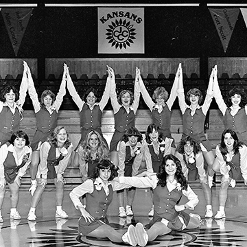 A squad of JCCC cheerleaders poses for a group portrait.