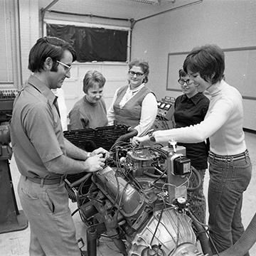 Students work on a vehicle engine in the Arts and Technology Building at JCCC.