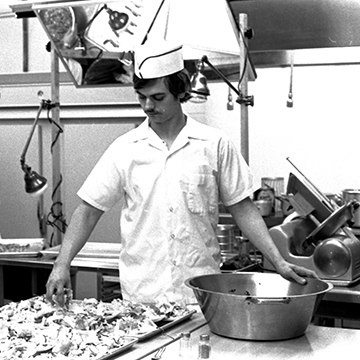 A culinary student works in a JCCC kitchen classroom.