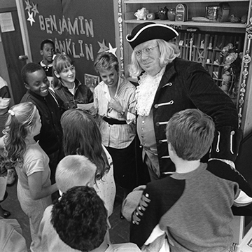 Historian Fred Krebs portrays Benjamin Franklin to a group of children.