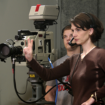 Students record a meeting with a videocamera.