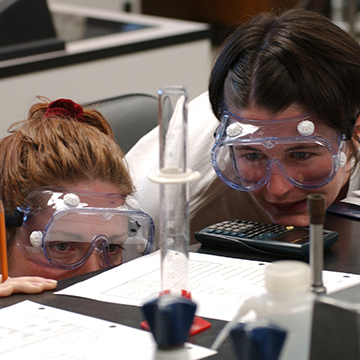 Two healthcare students look over a science project.