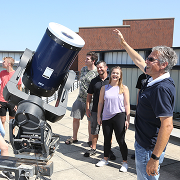 Students check out telescopes at the Paul Tebbe Observatory on the roof of the  Classroom Laboratory Building (CLB)
