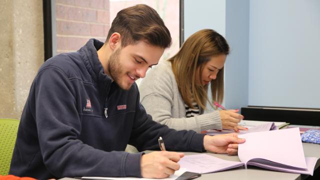 Two JCCC students studying together at a table