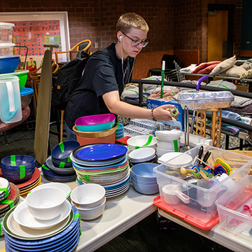 a student looks through kitchenware donated to the thrift and thrive market
