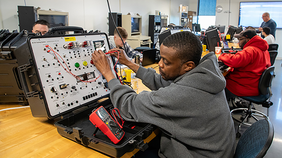 Student working on a circuit board