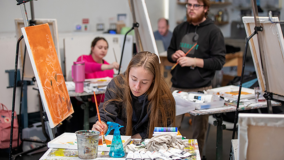 Student painting in a Fine Arts & Design studio