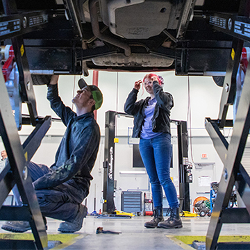 JCCC students work on the undercarriage of a vehicle
