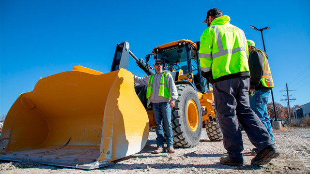 A JCCC instructor talks to students about a front loader.