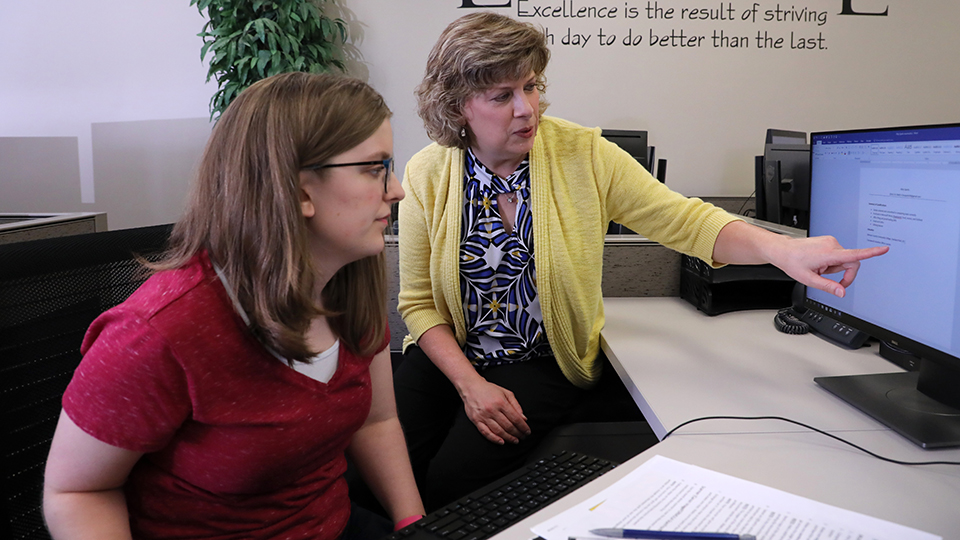 Student working with Business Office Technology professor
