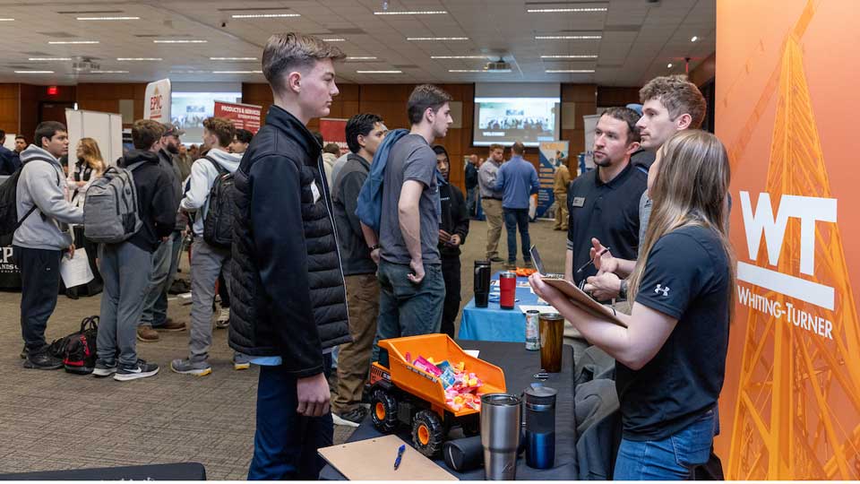 Construction Management students visiting a table during Career Day