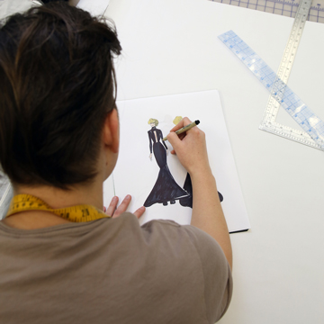 A student sketches a dress design concept