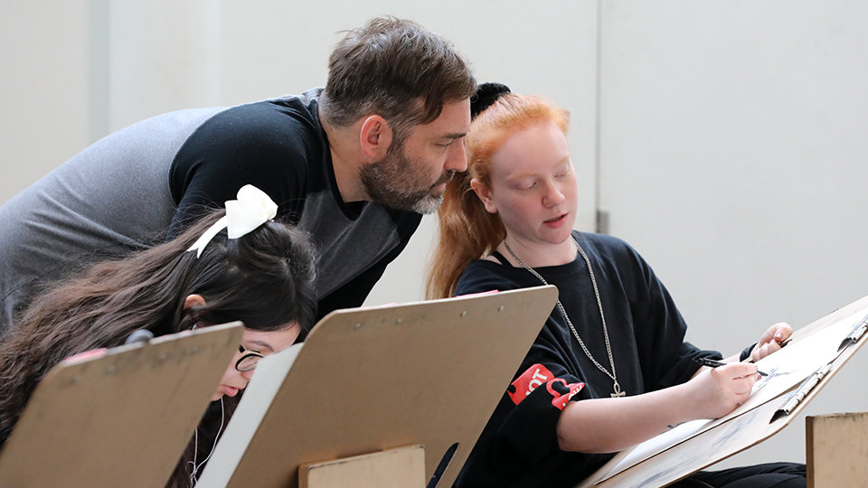 Professor working with a drawing student