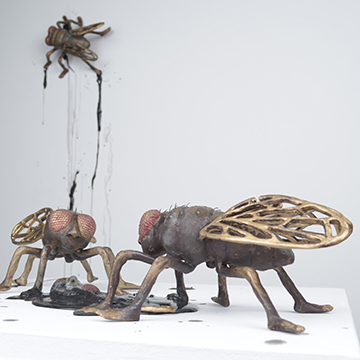 Metal sculptures of giant flies