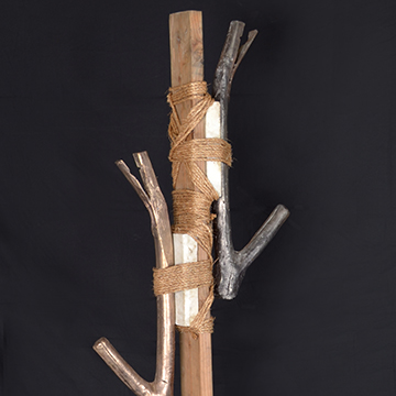 Sculpture of metal branches bound to a wooden stick
