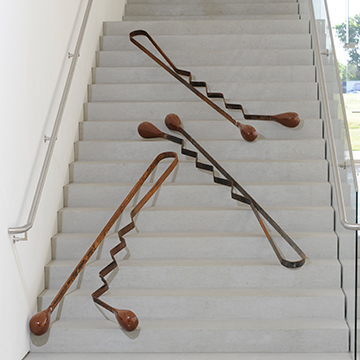 Giant sculpture of bobby pins displayed on the steps inside the Nerman Museum