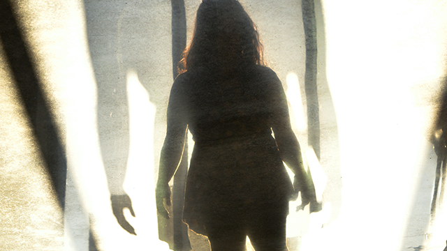 Silhouette of a woman surrounded by white walls