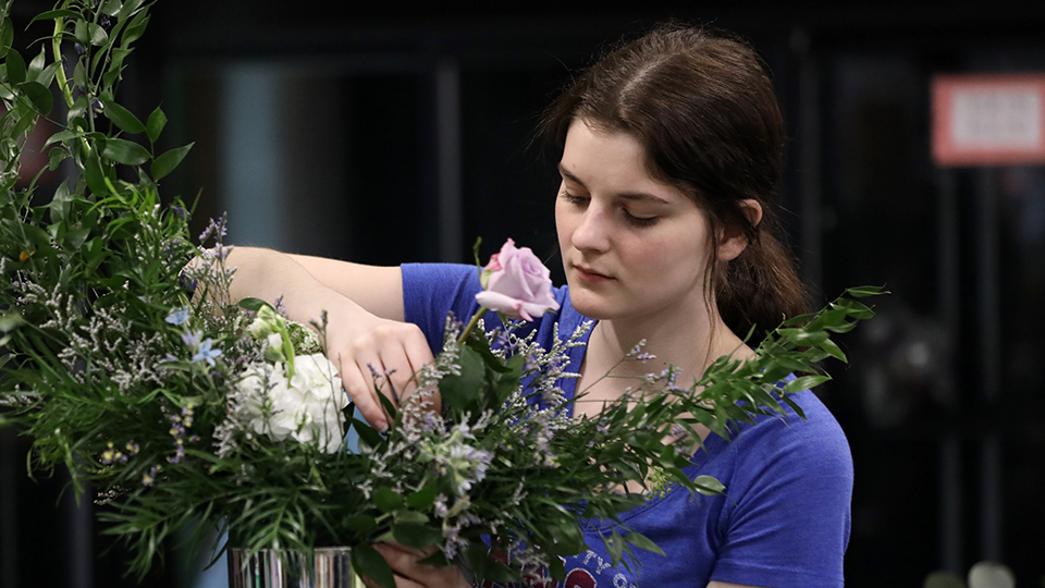 A student working on a floral arrangement