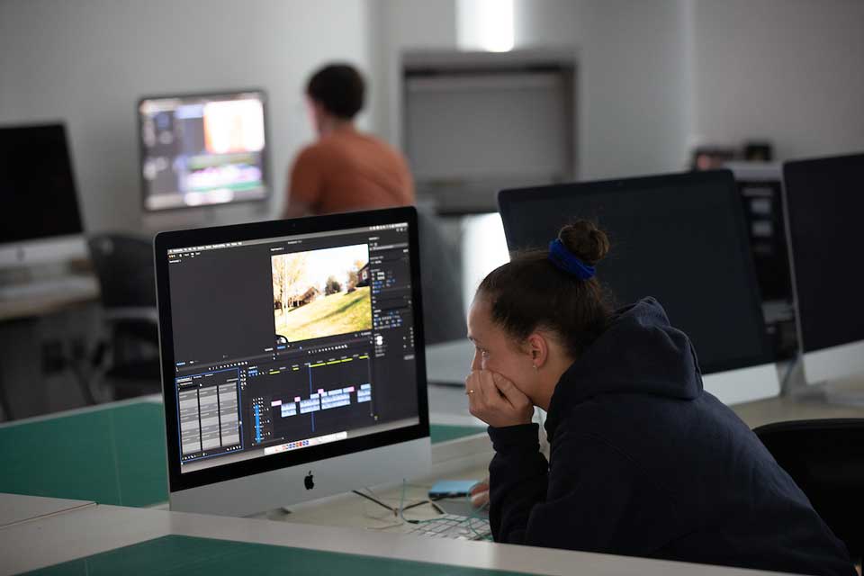 Two students working in the film lab in the Fine Arts and Design Studios building