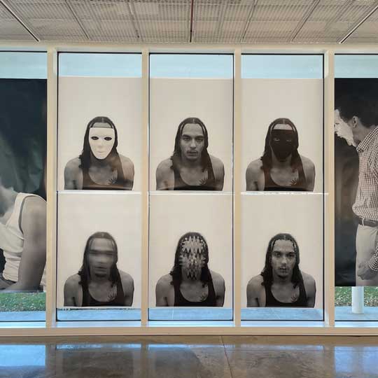Black and white mural prints collectively creating an installation of self-portraits in the FADS gallery for Final Project in Foundations in Photography