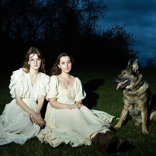 Color photograph of two women and a dog at night created for the Color class 