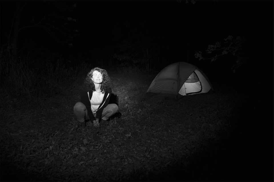 Silver gelatin print of woman in a tent outside at night created for the View Camera class