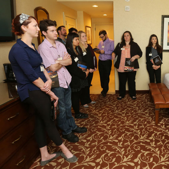 Students listening to a lecture in a hotel room