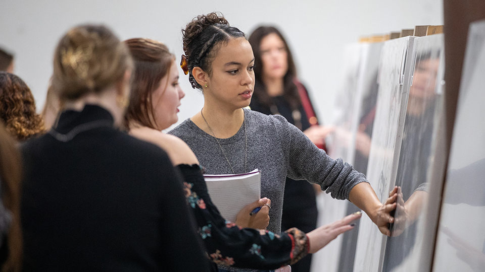 Two students examining a poster at poster exhibit