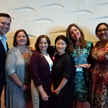 Group photo with a trophy from the Symphony Showhouse